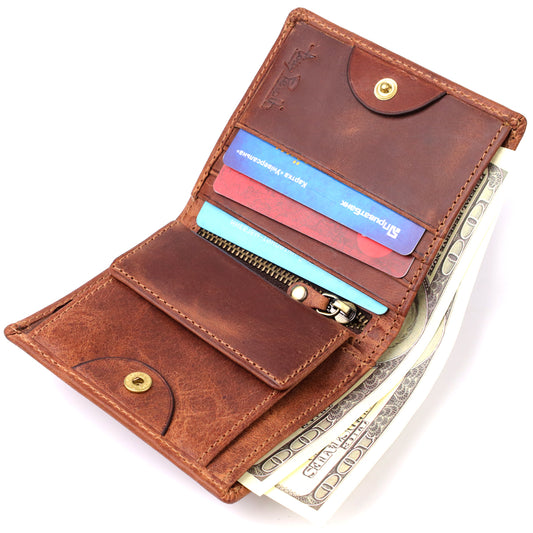 Tony Perotti Arno 1165 whisky brown leather bifold wallet open and filled — dollar banknotes and several bank cards in the slots