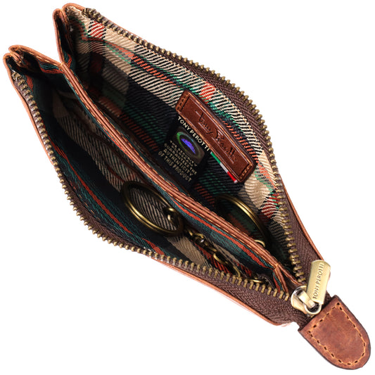 Tony Perotti Arno 3350 whisky key case open close-up — tartan-check lining, two key rings on chains and the Tony Perotti hologram label on a leather tab