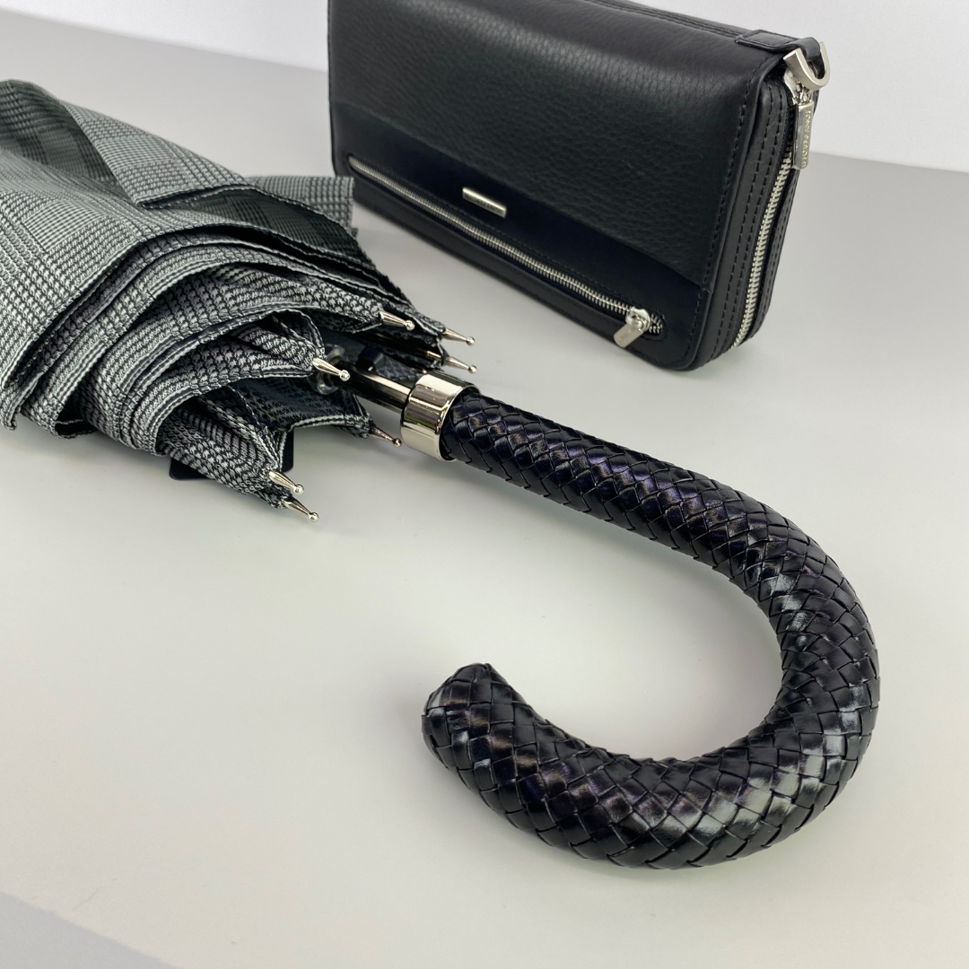 Pasotti umbrella next to Tony Perotti leather clutch bag