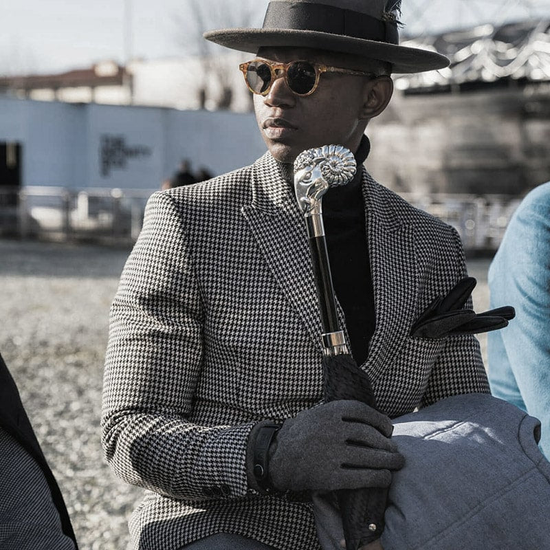 Man with Pasotti umbrella with silver handle in the form of a ram