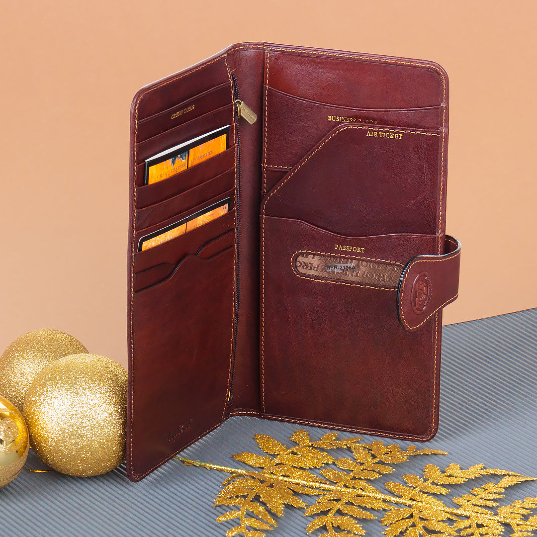 Tony Perotti brown leather travel wallet with card slots on a textured surface with decorative elements