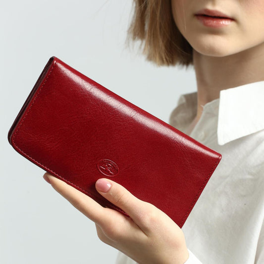 Red wallet held by a person against a neutral background