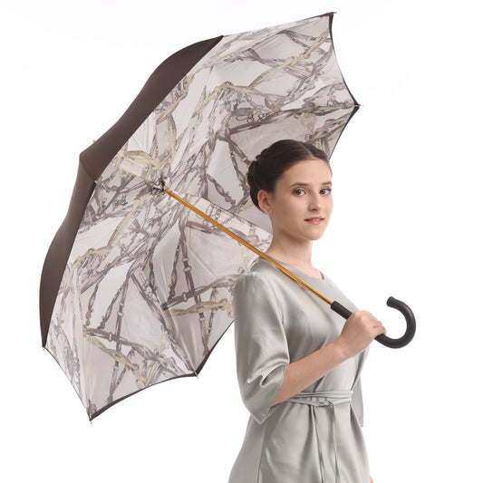 Model holding Pasotti umbrella with equestrian-print lining