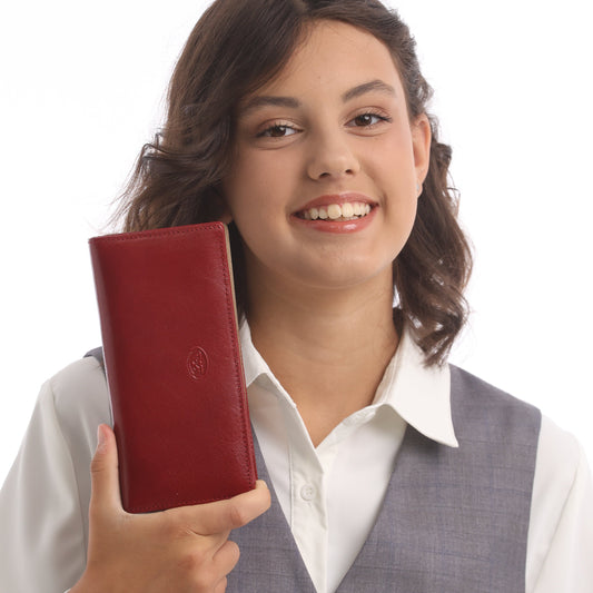 Woman holding a red leather wallet against a white background