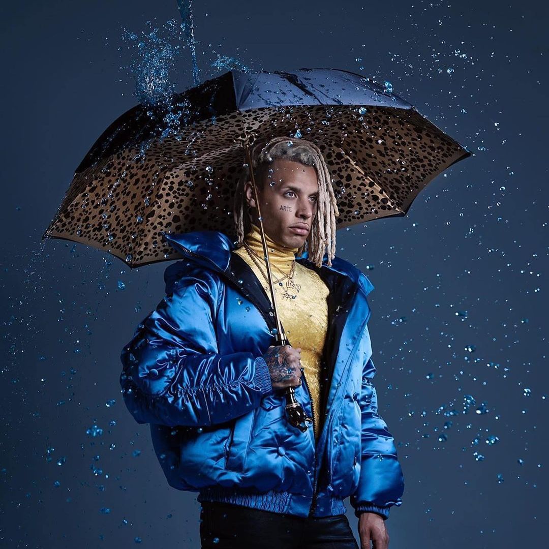 A man with a Pasotti cane umbrella and drops of water