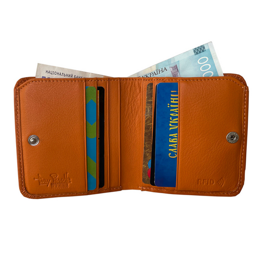 Open Tony Perotti orange RFID bifold wallet with cards and folded banknotes
