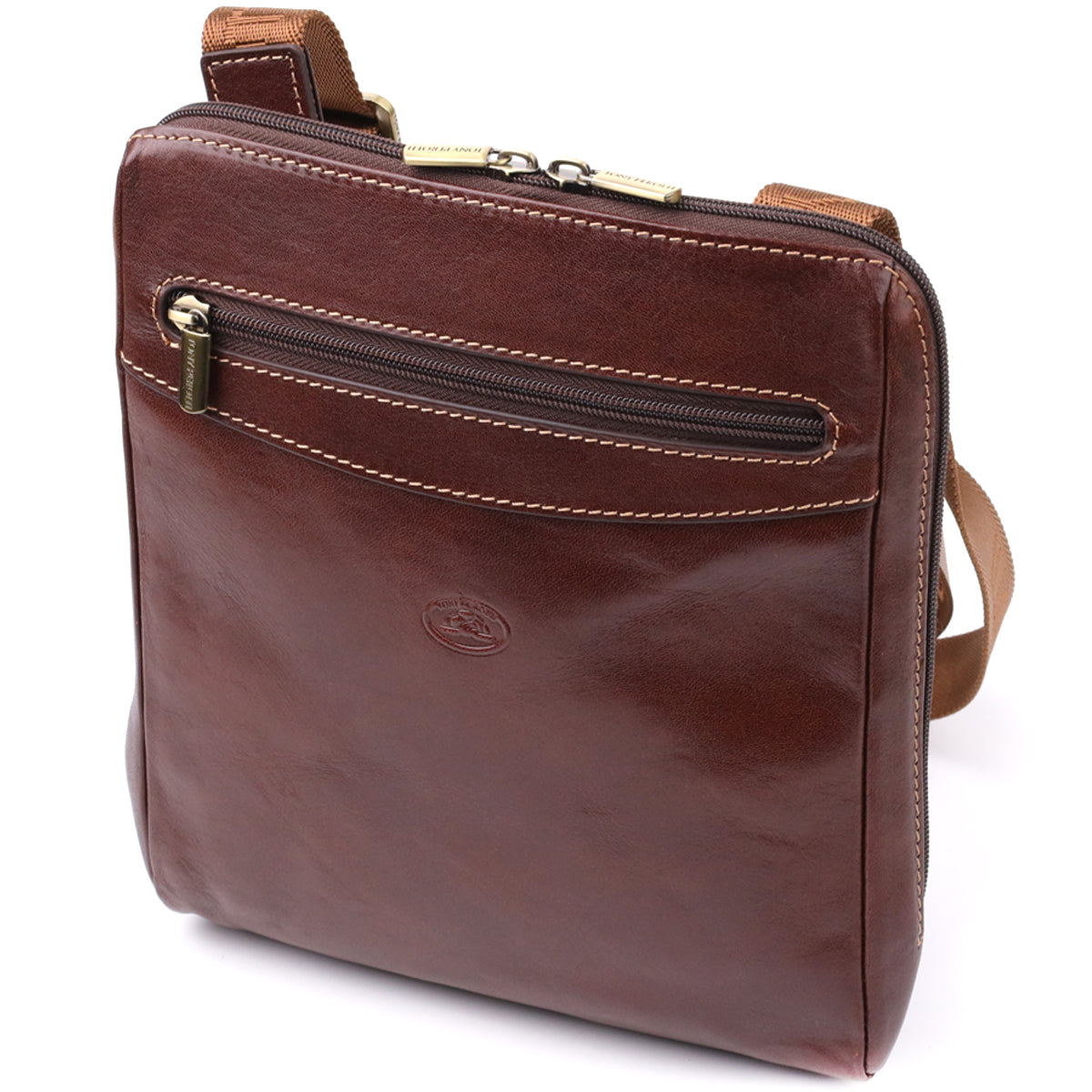 Three-quarter angled view of the Tony Perotti Italico 9137-20 dark brown leather crossbody bag showing the front zip pocket, embossed oval emblem and tan jacquard shoulder strap
