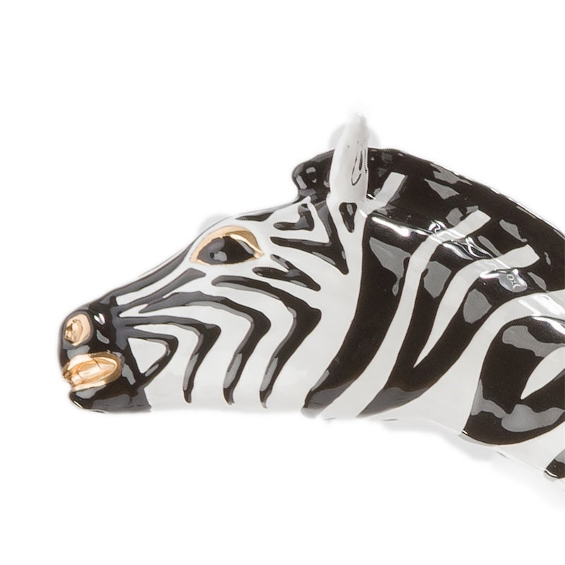 Zebra head in profile with gold-tone eye and nostrils, macro close-up, handcrafted in Italy