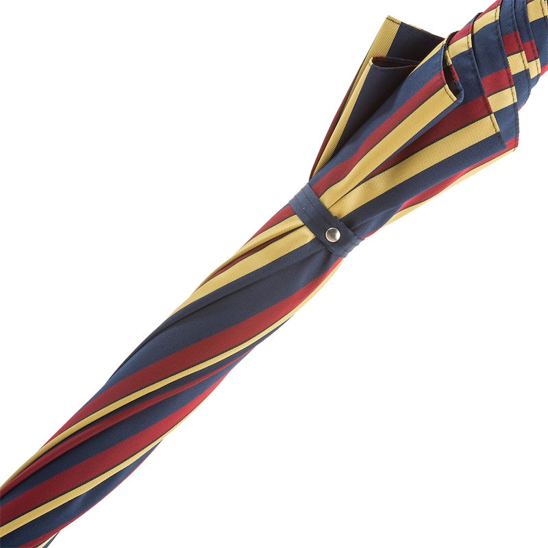 Fabric strap with silver-tone snap button on the furled striped canopy