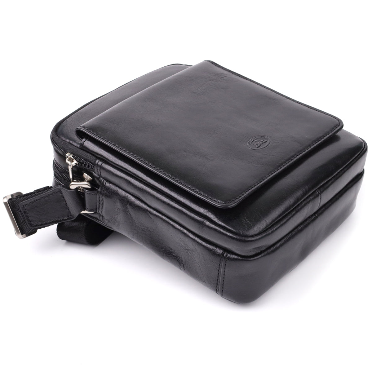 Front three-quarter view of the closed Italico 9148-17 black bag resting on its base, showing the flap pocket and embossed oval emblem