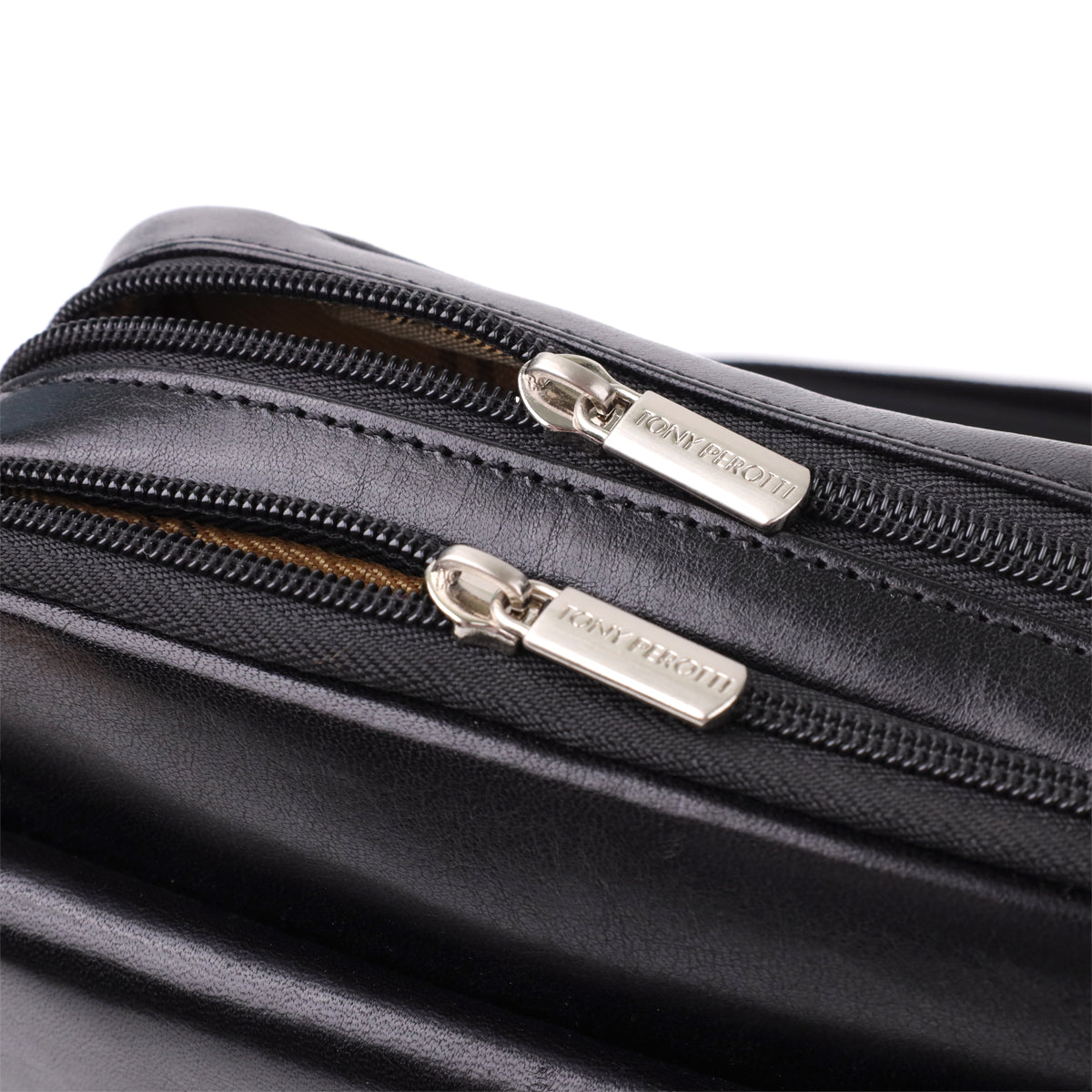 Macro shot of the two main-compartment zip pullers on the Italico 9148-17 black bag, both stamped TONY PEROTTI