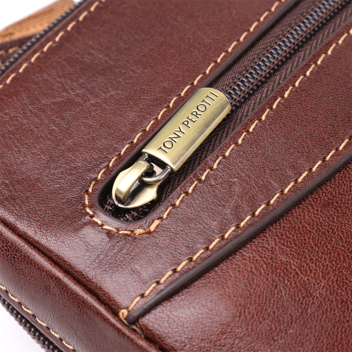 Front three-quarter view of the closed dark brown Italico 9137-20 bag resting on its base, showing the zip pocket and embossed oval emblem