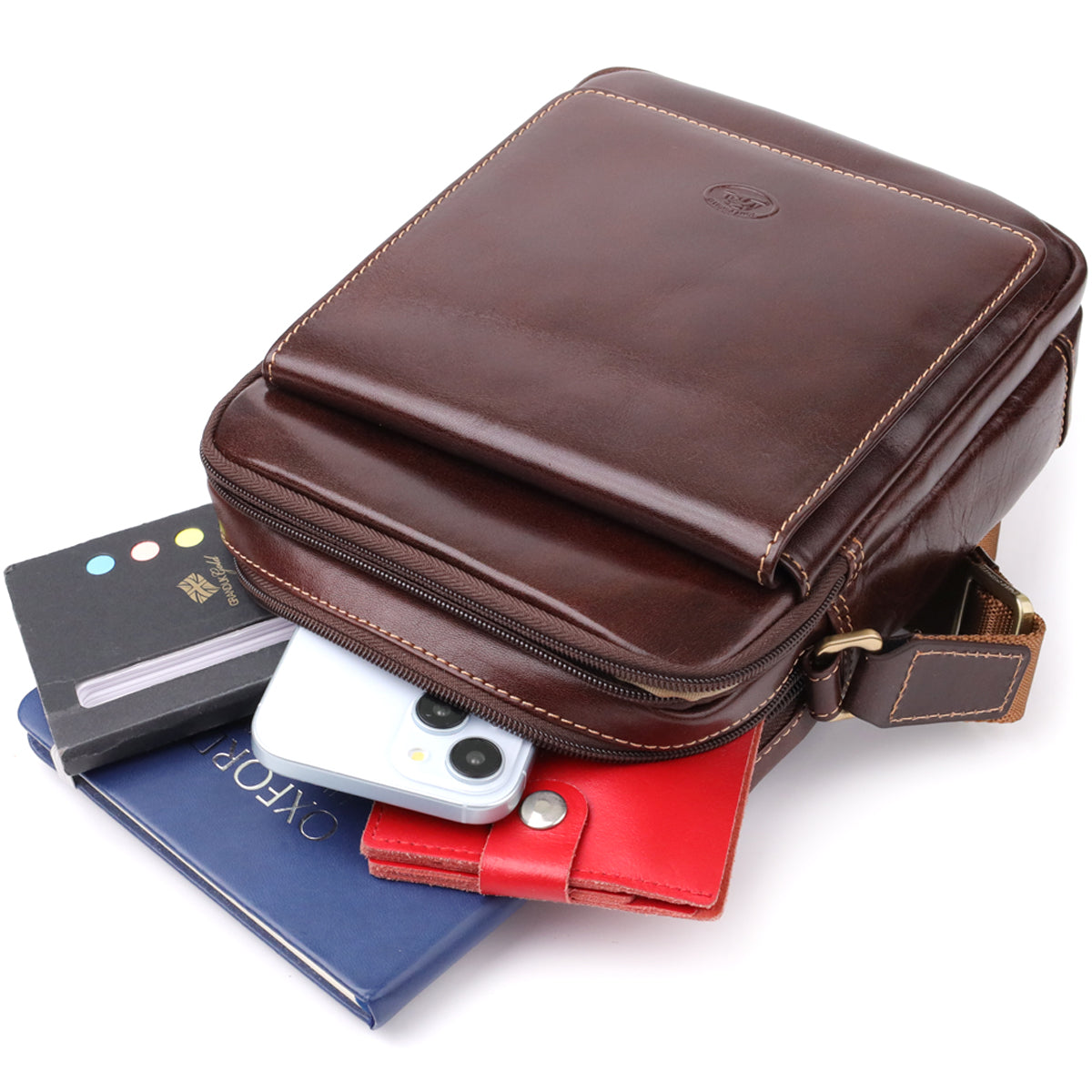 Italico 9148-17 bag styled with a notebook, a phone and a red leather cardholder spilling from the front pocket to show its capacity