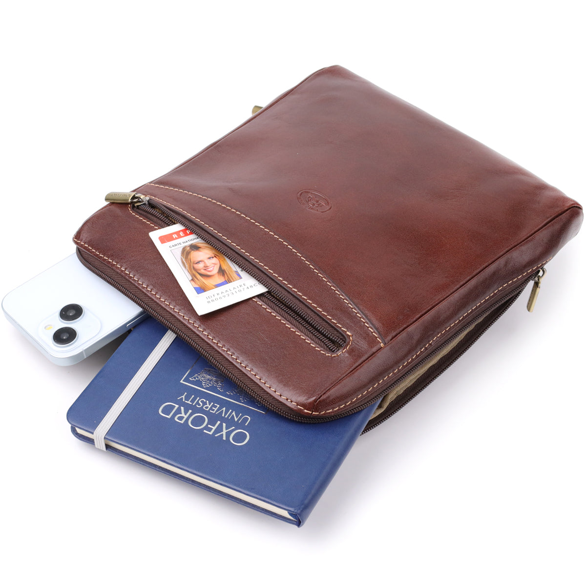 Dark brown Italico 9137-20 bag styled with a phone, an ID card and a notebook peeking from the front zip pocket to show its capacity