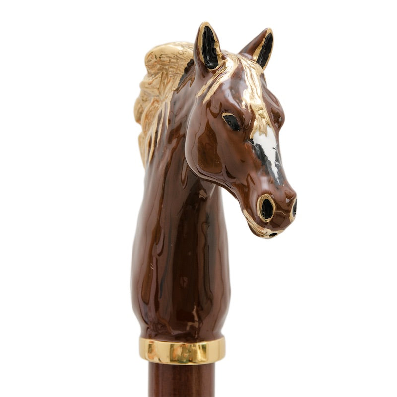 Horse head from the front with a white blaze above a gold-tone collar, handcrafted in Italy