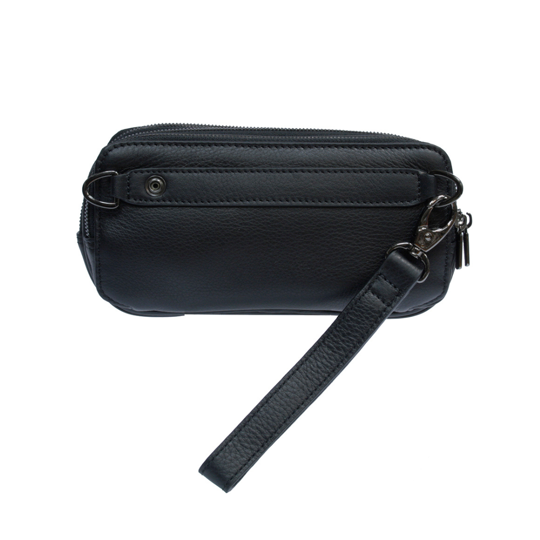 Back of the black Tony Perotti leather clutch — horizontal leather strap on a snap with D-rings and the detachable wrist strap attached