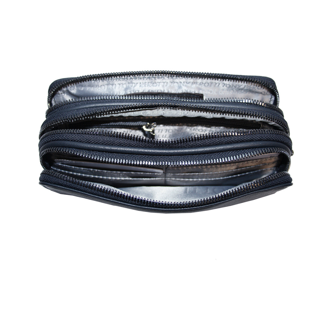 Open interior of the navy Tony Perotti clutch — three zip compartments with branded printed lining an inner zip pocket and leather card slots