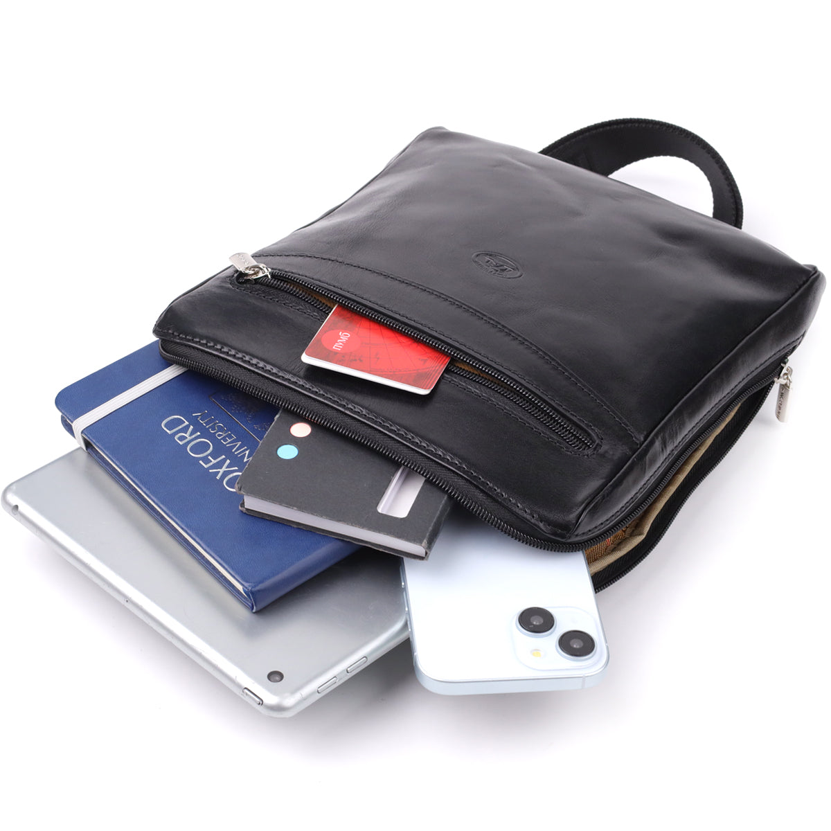Italico 9137-20 bag styled with an iPad, a passport, a notebook, a phone, a power bank and cards spilling from the front pocket to show its capacity