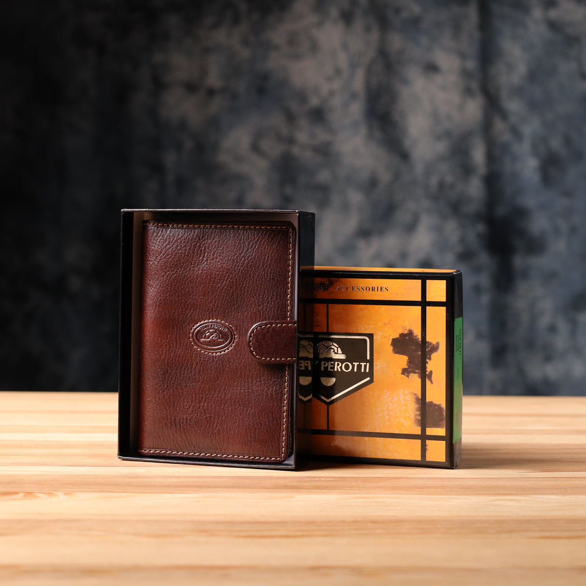 Tony Perotti Italico 1423A moro document holder in its open branded gift box on a wooden surface, box lid beside it