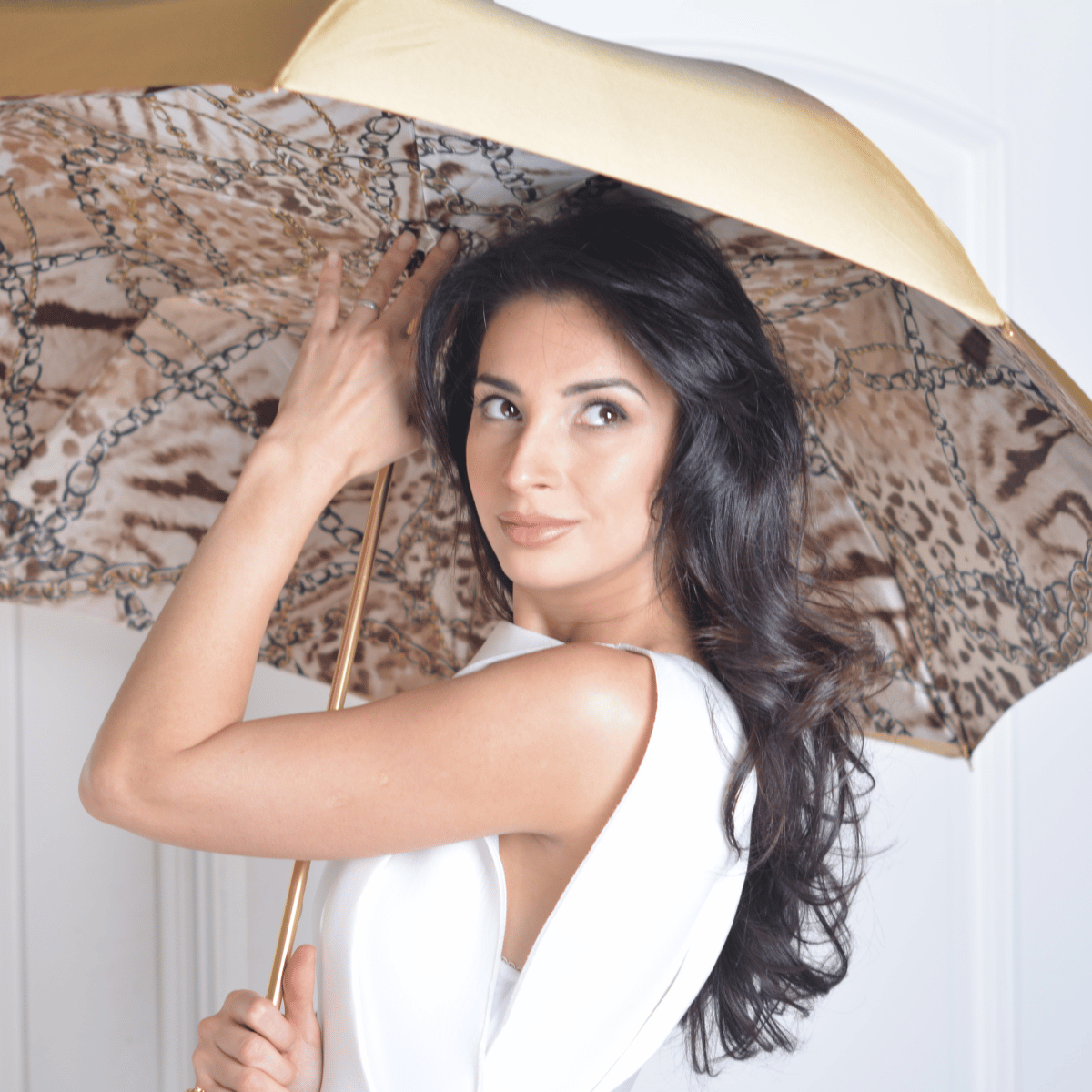 Model holding the open Pasotti cane umbrella, leopard-print inner canopy in view — 189-58002/9-2