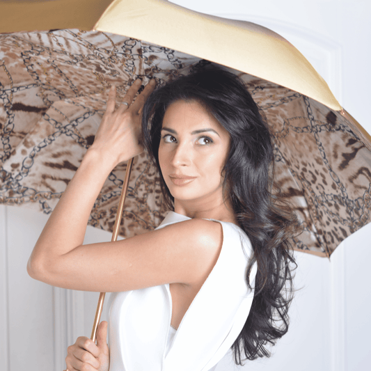 Model holding the open Pasotti cane umbrella, leopard-print inner canopy in view — 189-58002/9-2