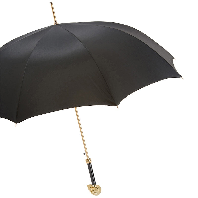 Open black umbrella from the side with gold-tone shaft and skull handle