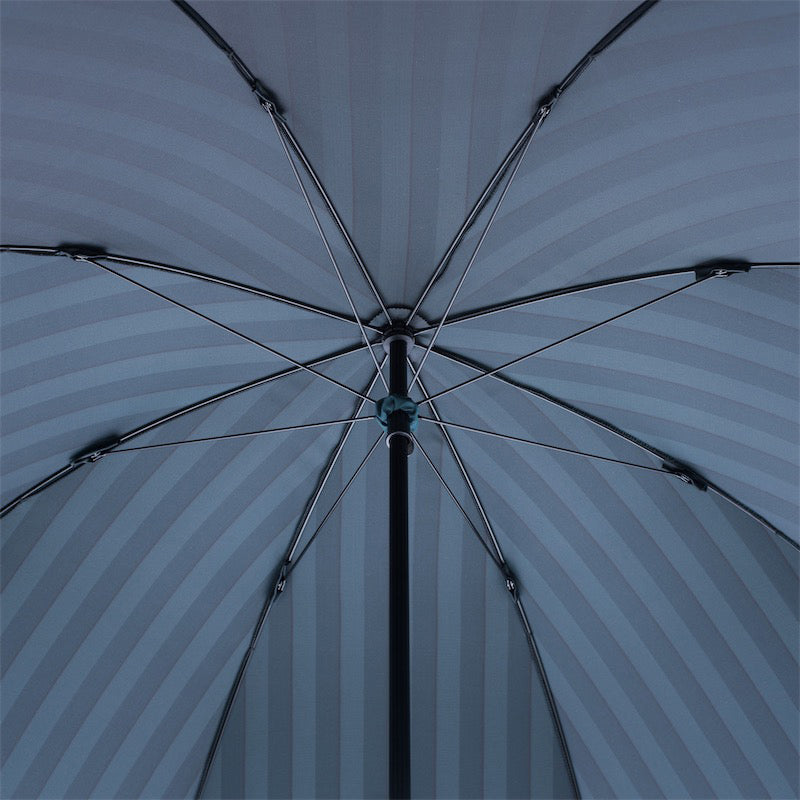 Underside of the open striped canopy with eight ribs and black shaft