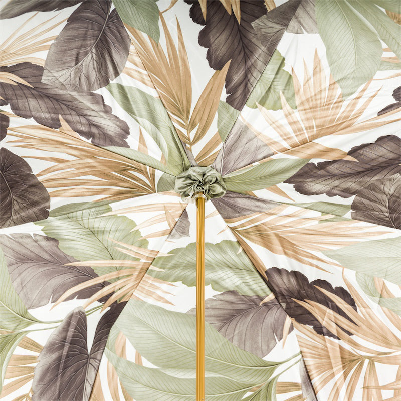 Inside of the canopy: sage green, beige and taupe tropical leaves on a white ground