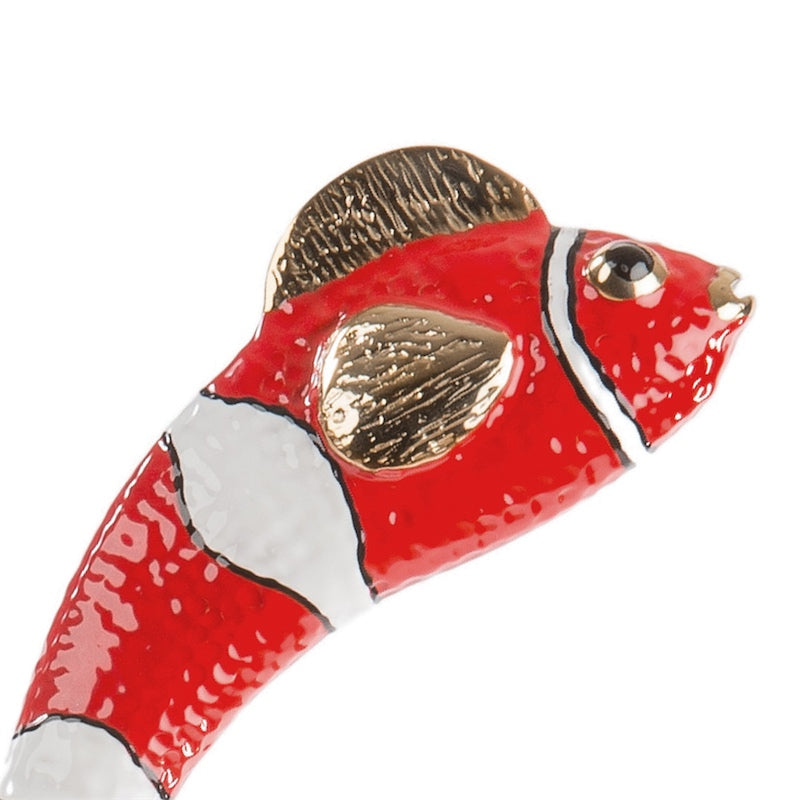 Red enameled fish with white bands and textured gold-tone fins, macro close-up