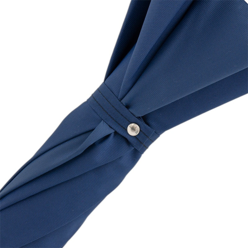 Fabric strap with silver-tone snap button on the furled navy canopy