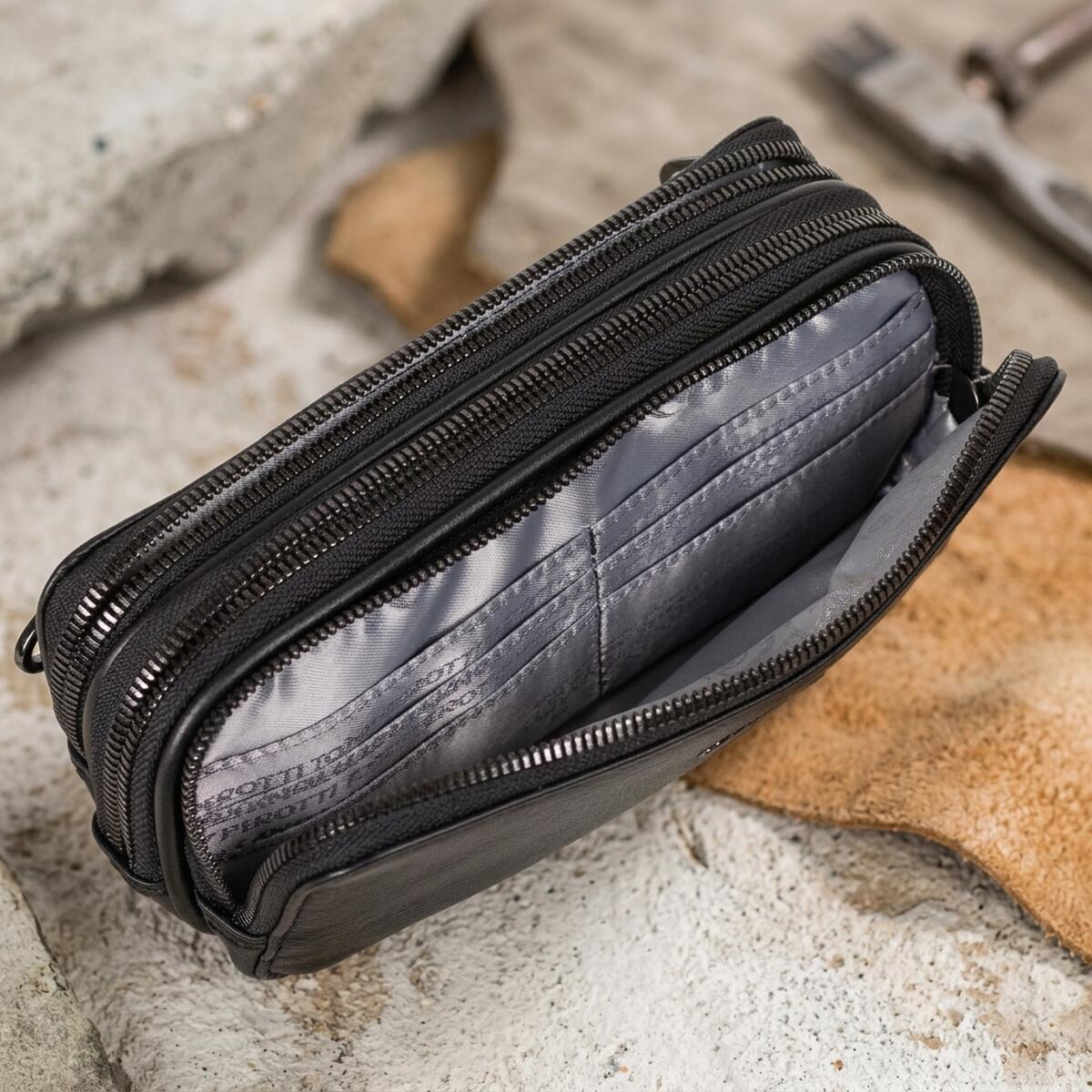 Open black Tony Perotti clutch — three zip compartments with leather card slots and printed lining