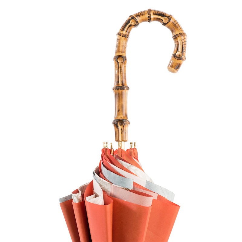 Bamboo crook handle above the furled double canopy with gold-tone rib tips