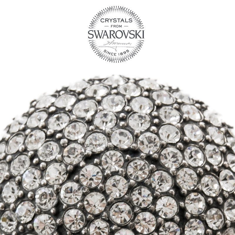 Clear Swarovski crystals in a dark silver-tone setting, macro close-up, handcrafted in Italy