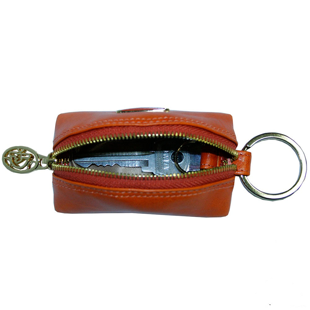 Tony Perotti Topkapi KR-186 mandarino — the case unzipped with a car key and fob inside, showing the light grey lining and the split ring on its leather tab