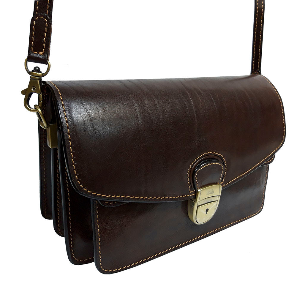 Italico 8264 moro at an angle on its shoulder strap — the aged-brass clasp lock struck with the Tony Perotti turtle