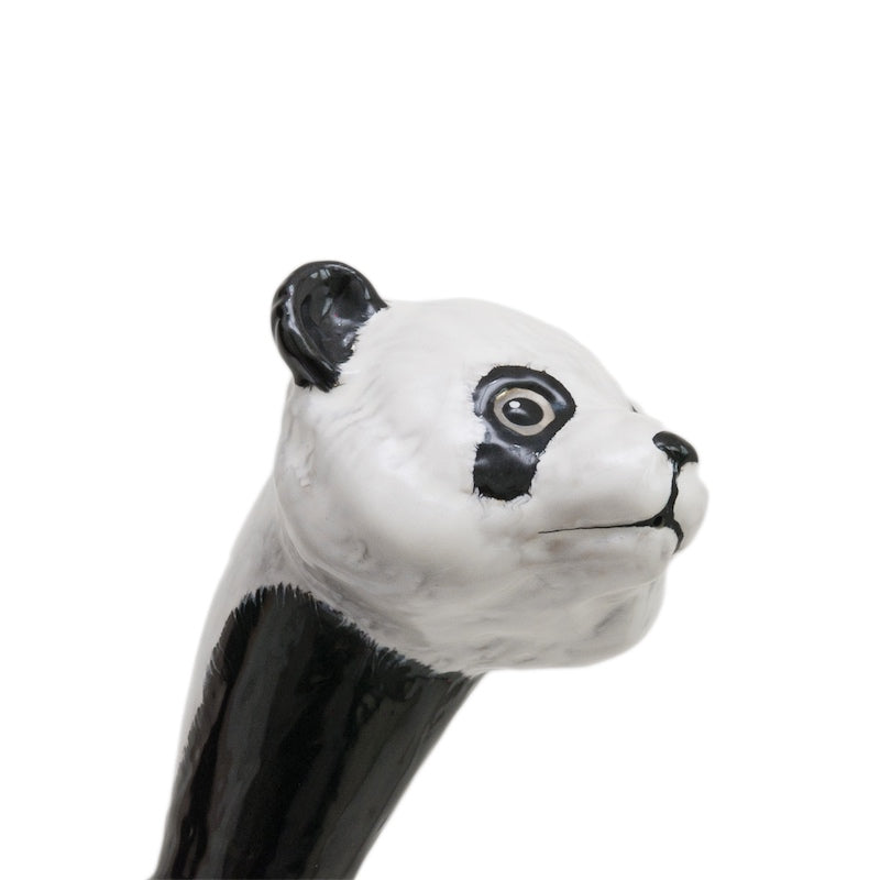 White enameled panda head with black ears and eye patches, three-quarter close-up