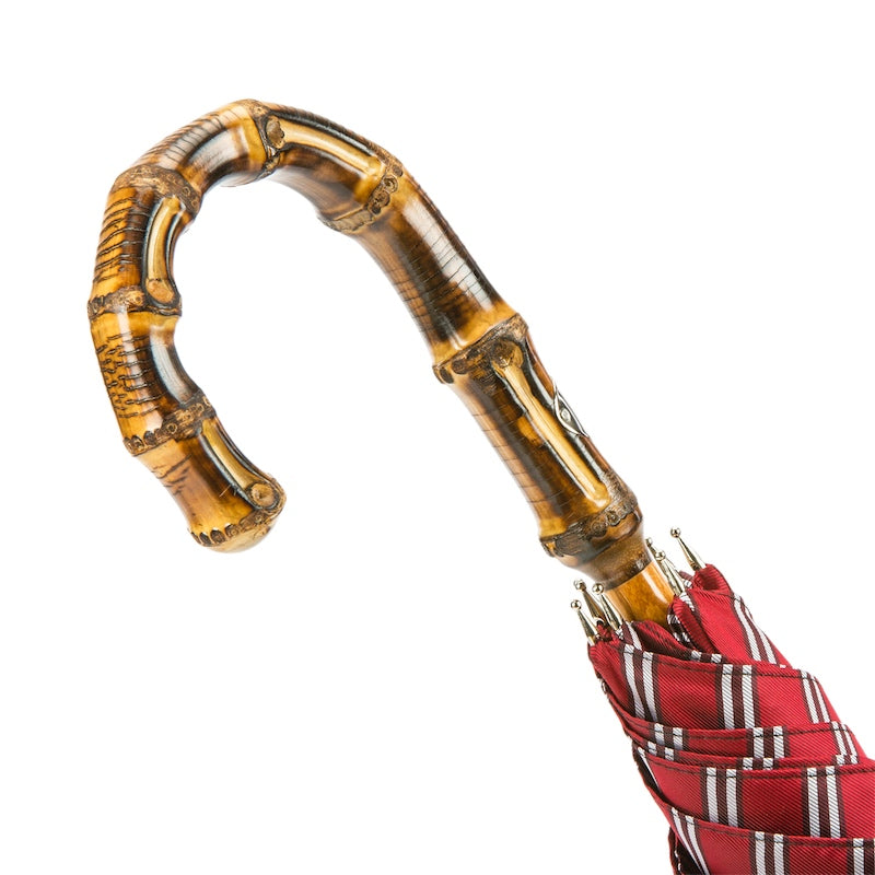Bamboo crook handle with natural nodes and flamed markings, close-up, handcrafted in Italy