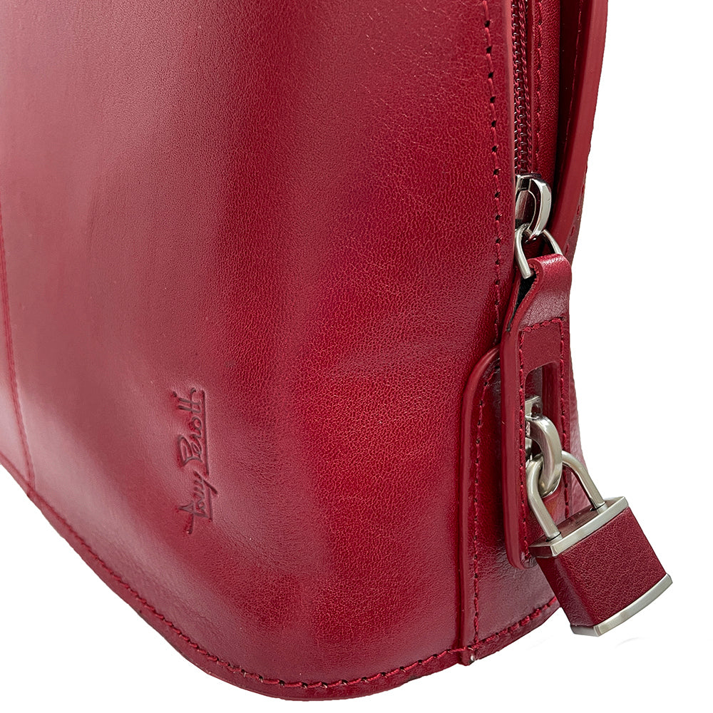 Detail of the red Tony Perotti Italico 8149 bag — embossed Tony Perotti signature, side zip and the padlock on the pull