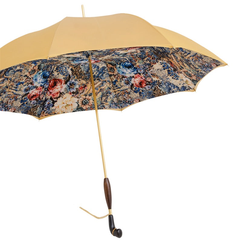 Open umbrella from the side: golden yellow outer canopy, floral print inside and wooden handle with chain
