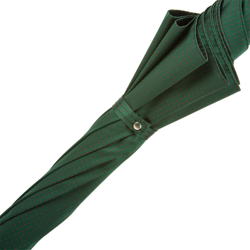 Furled dark green canopy held by the fabric strap