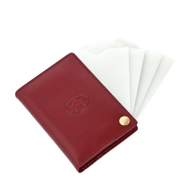 Red leather business card holder with clear plastic sleeves fanned out — Tony Perotti Italico 2028 rosso