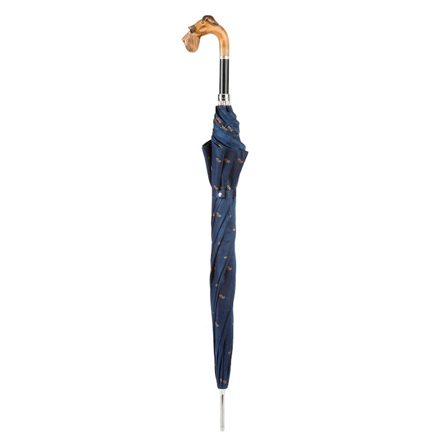 Closed blue umbrella standing upright with wooden schnauzer head handle