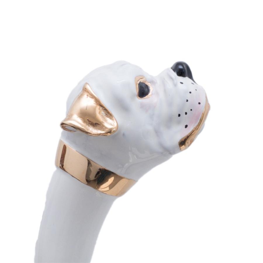 White enameled boxer head with gold-tone ear and neck band, side close-up