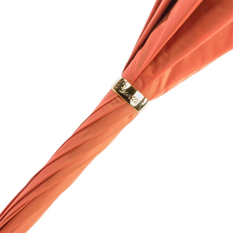 Gold-tone ring engraved Pasotti on the furled coral canopy