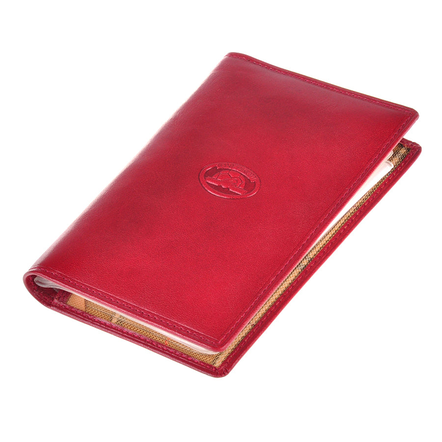 Angled view of the closed red Tony Perotti Italico 1896 rosso document holder with the sleeve booklet visible at the edge