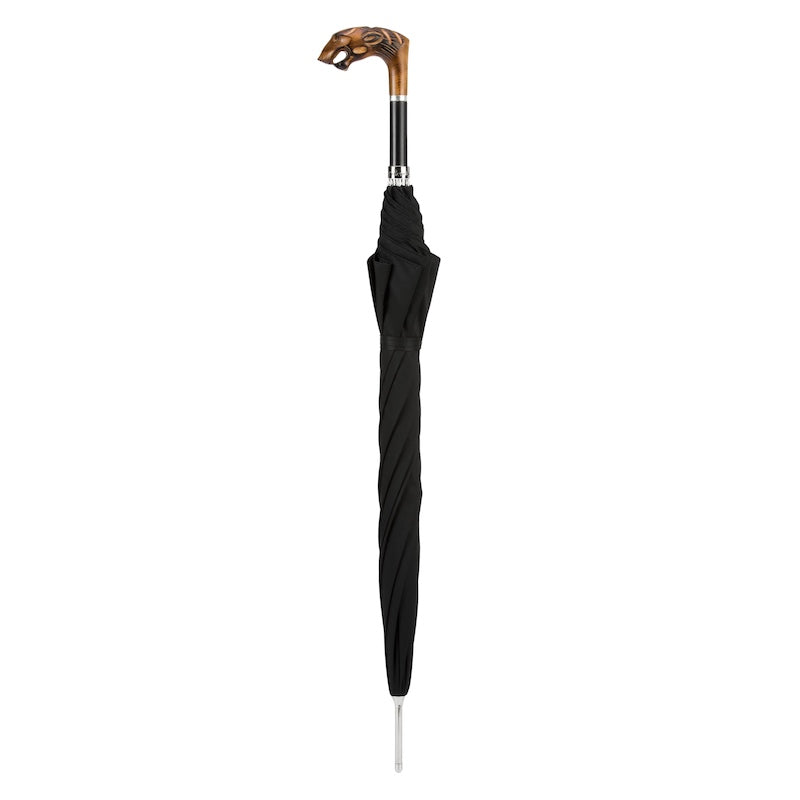 Closed black umbrella standing upright with carved tiger head handle