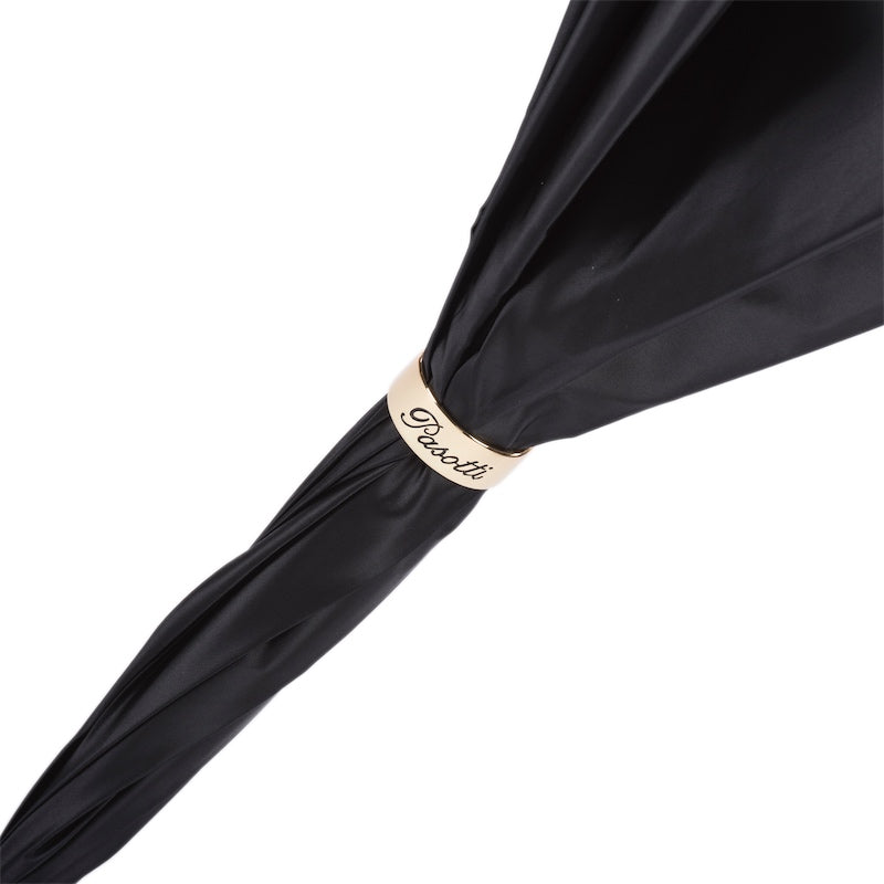 Gold-tone ring with a cream band and the Pasotti name on the furled black canopy