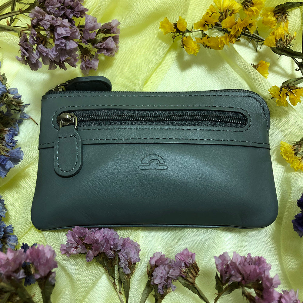 Tony Perotti New Rainbow 359 grigio — the grey key pouch photographed on a cloth with dried flowers