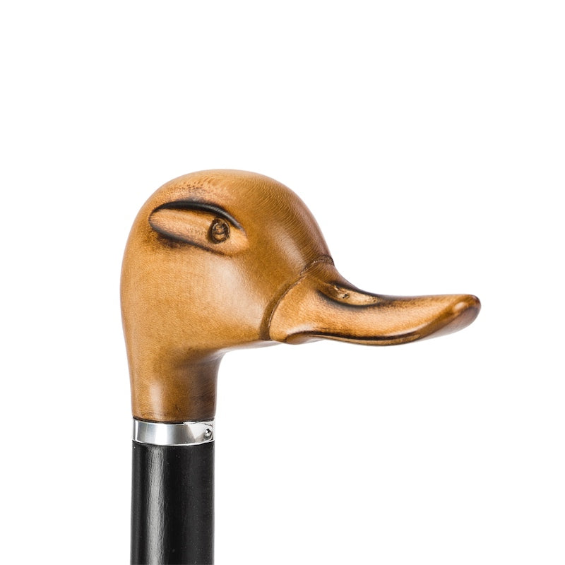 Hand-carved wooden duck head with carved eye and long bill, close-up, handcrafted in Italy