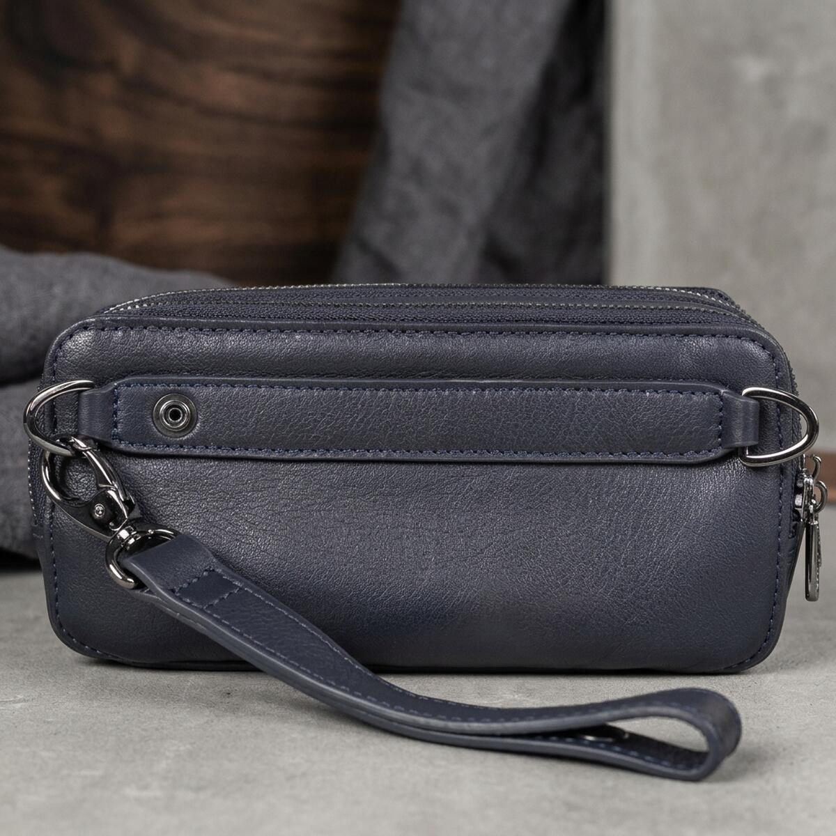 Back of the navy Tony Perotti clutch — leather strap on a snap with black-nickel D-rings and the detachable leather wrist strap